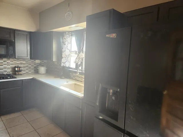 a bathroom with a granite countertop sink and vanity
