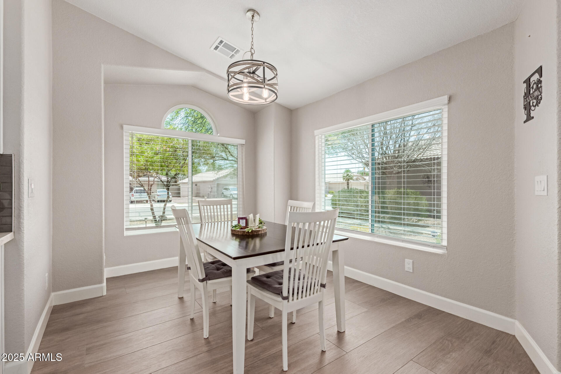 92 West Jasper Drive Gilbert, AZ 85233 - Photo 11 of 34 a dining room with wooden floor and a window