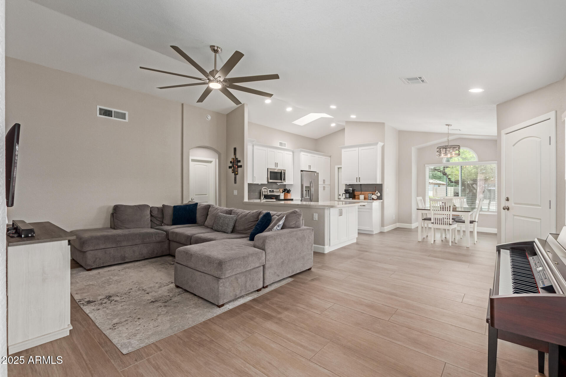 92 West Jasper Drive Gilbert, AZ 85233 - Photo 3 of 34 a living room with furniture kitchen view and a wooden floor