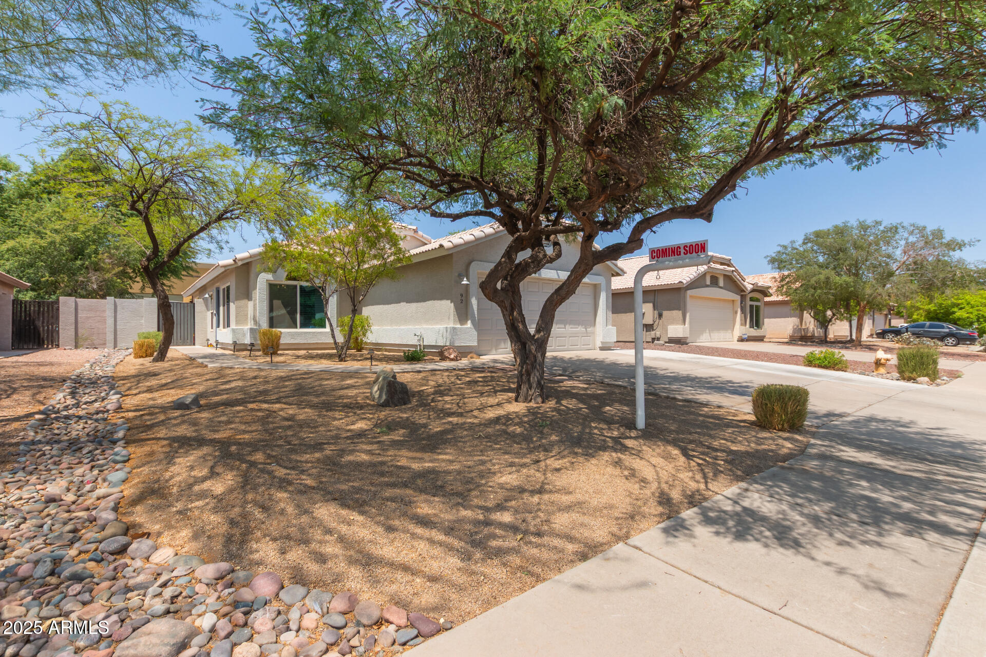 92 West Jasper Drive Gilbert, AZ 85233 - Photo 32 of 34 a backyard of a house with large trees and outdoor seating