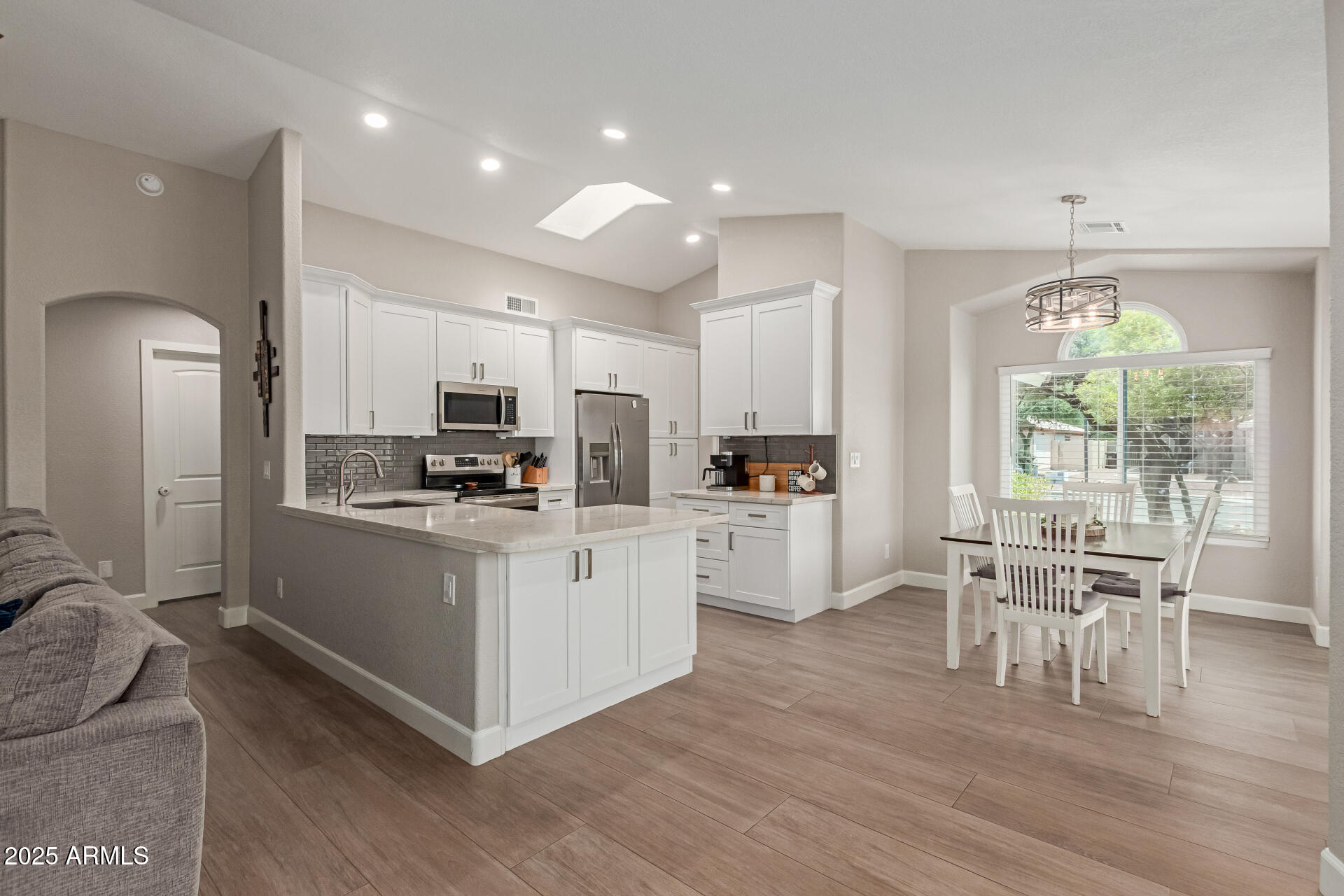 92 West Jasper Drive Gilbert, AZ 85233 - Photo 4 of 34 a kitchen with white cabinets and stainless steel appliances
