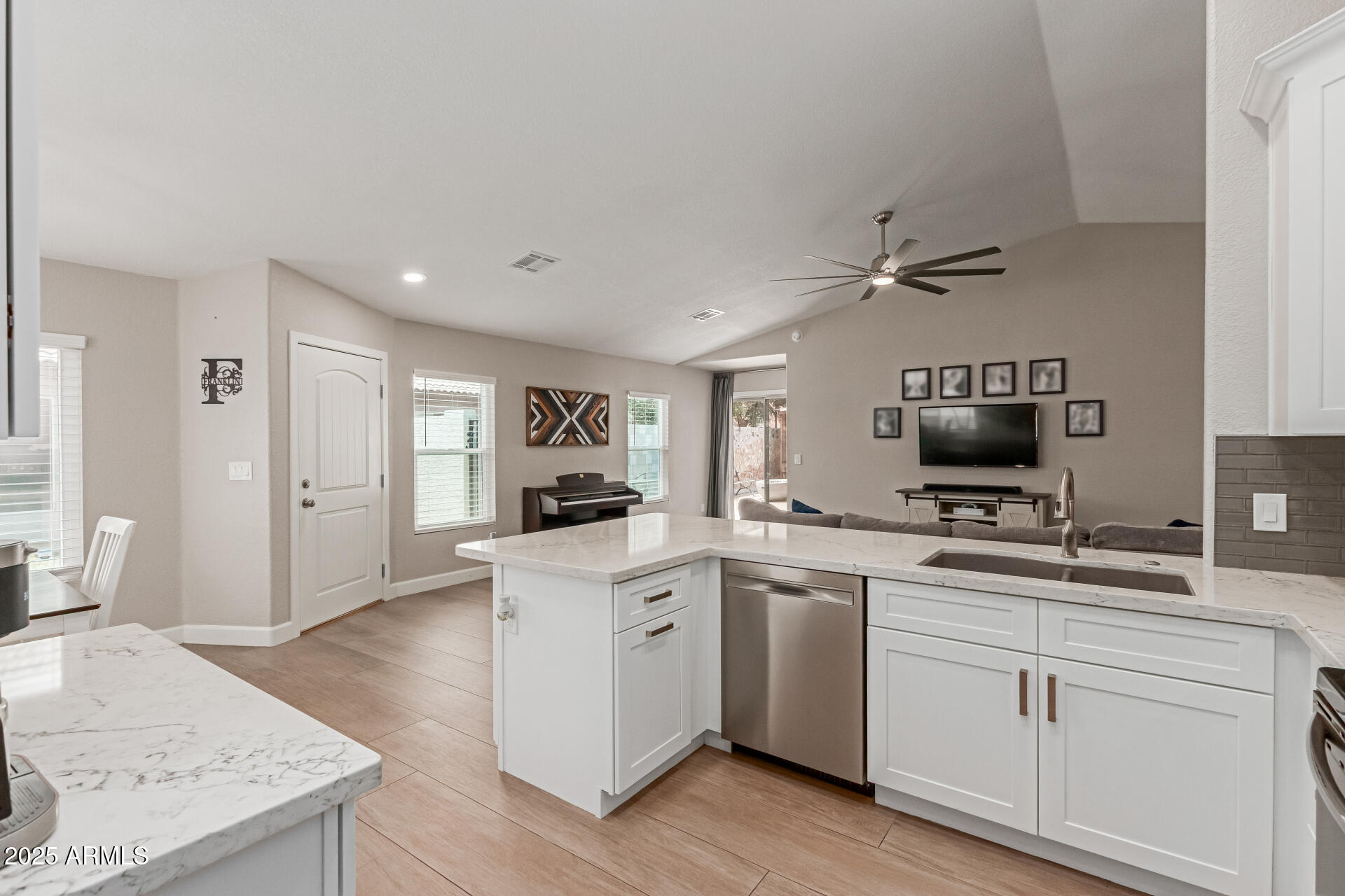 92 West Jasper Drive Gilbert, AZ 85233 - Photo 9 of 34 a open kitchen with white cabinets and sink