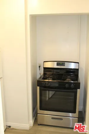 a stove top oven sitting inside of a kitchen