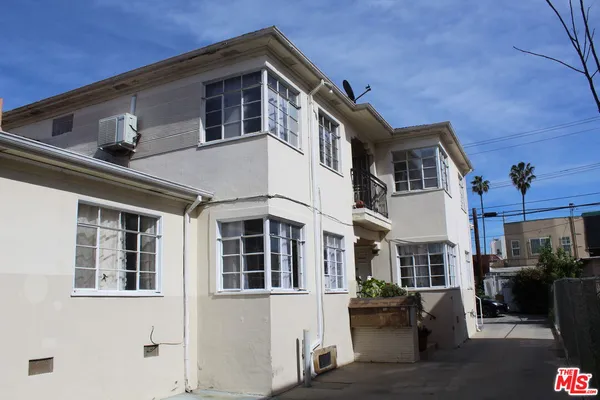 a front view of a residential houses with yard