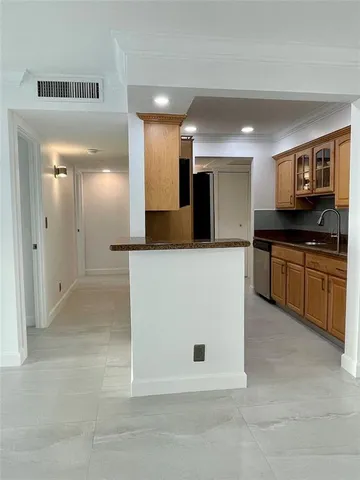 a large kitchen with cabinets and stainless steel appliances