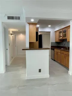 a large kitchen with cabinets and stainless steel appliances