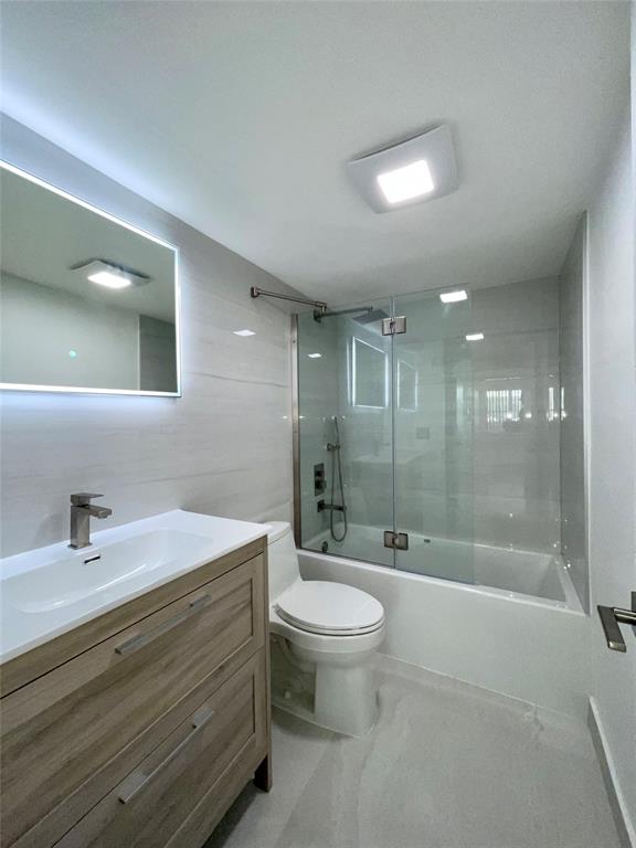 1515 East Broward Boulevard, Unit 124 Fort Lauderdale, FL 33301 - Photo 5 of 12 a bathroom with a bathtub shower sink mirror and toilet