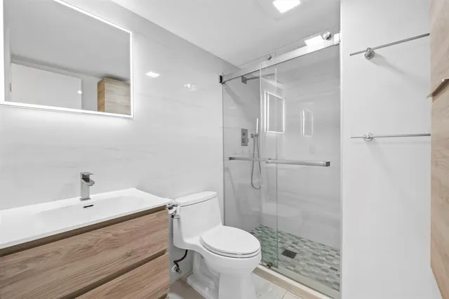 a bathroom with a sink toilet and shower