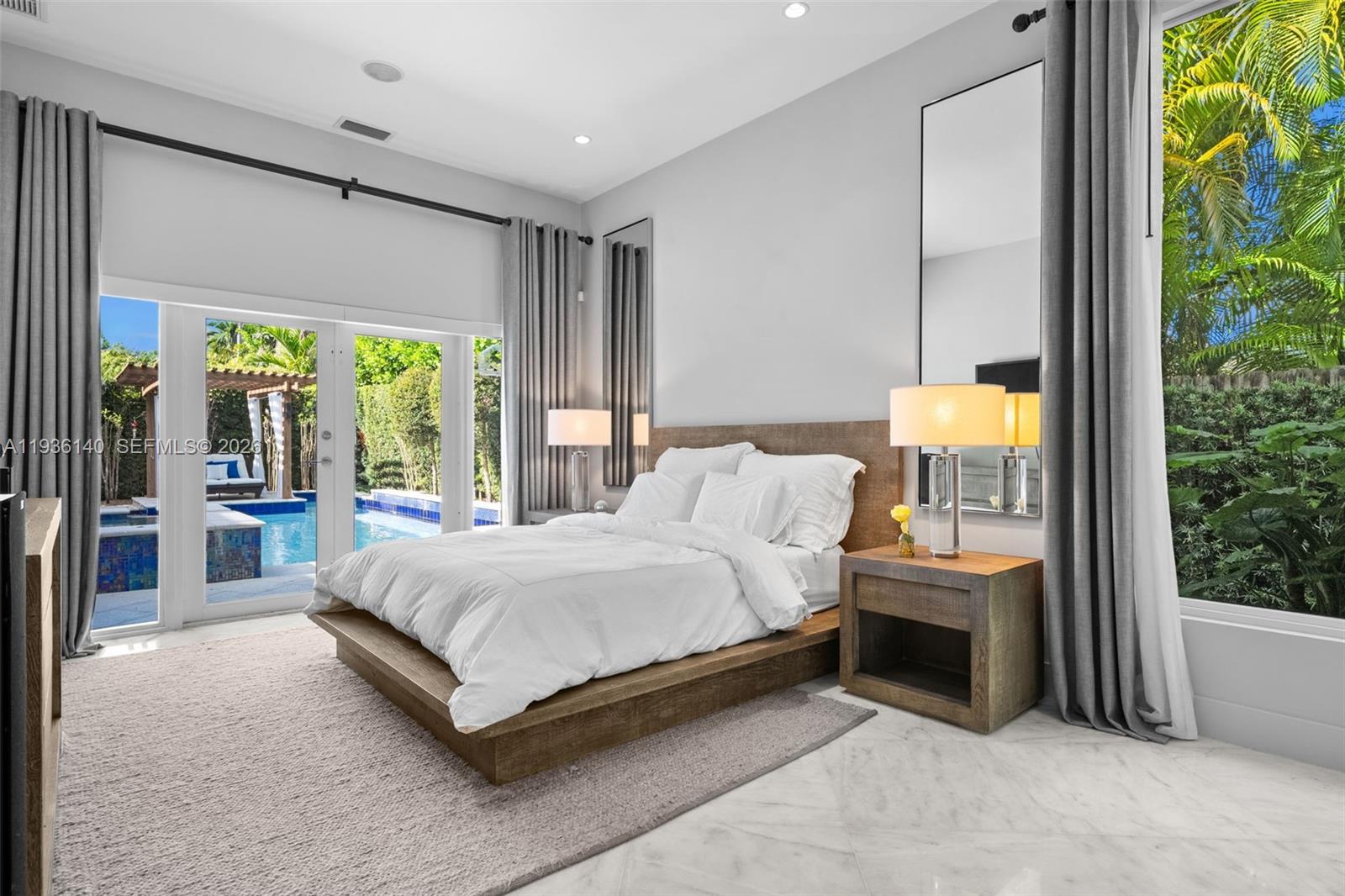 1251 Kane Concourse Bay Harbor Islands, FL 33154 - Photo 15 of 52 a spacious bedroom with a bed and a large window