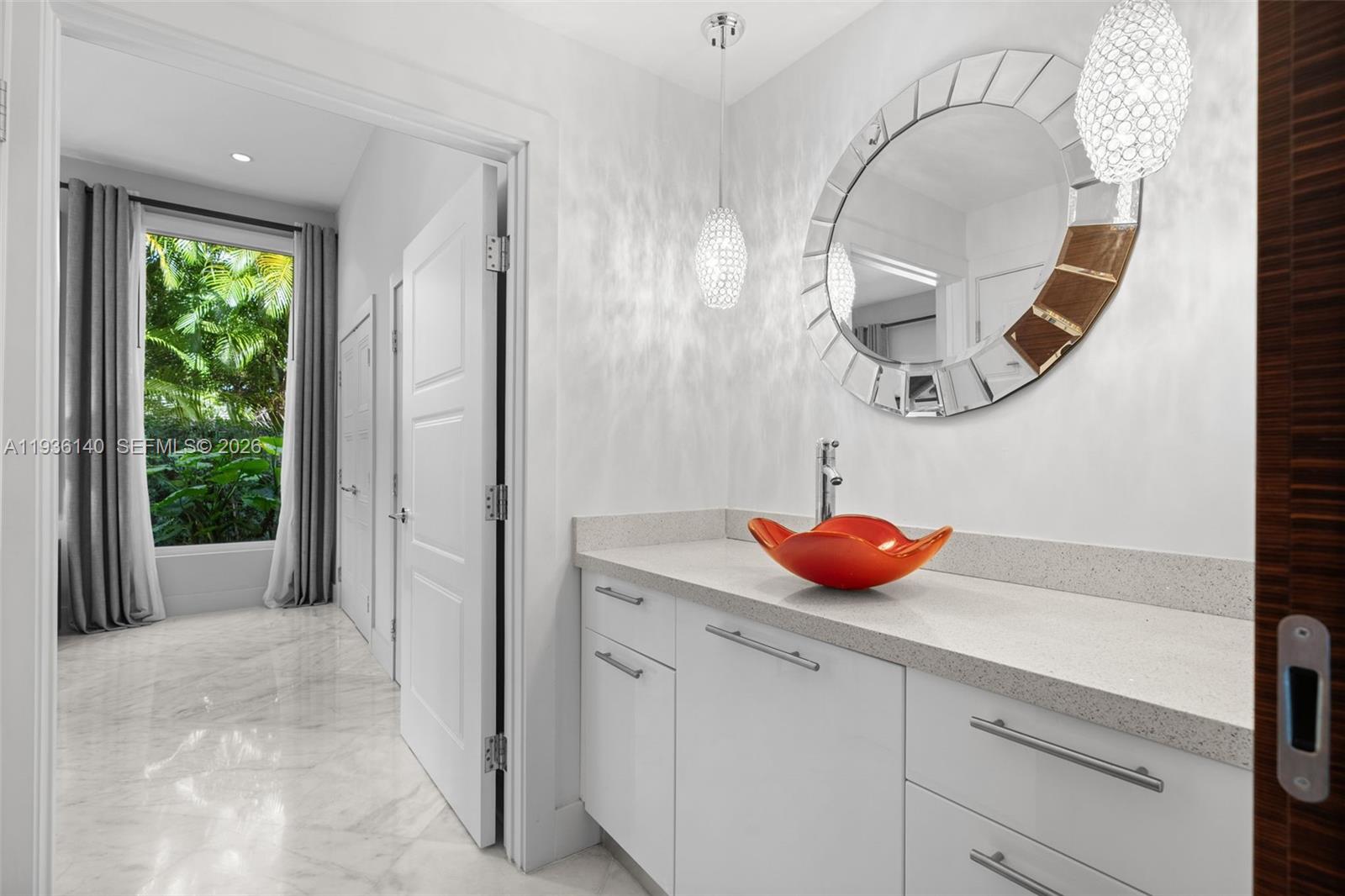 1251 Kane Concourse Bay Harbor Islands, FL 33154 - Photo 18 of 52 a view of bathroom with a mirror and window
