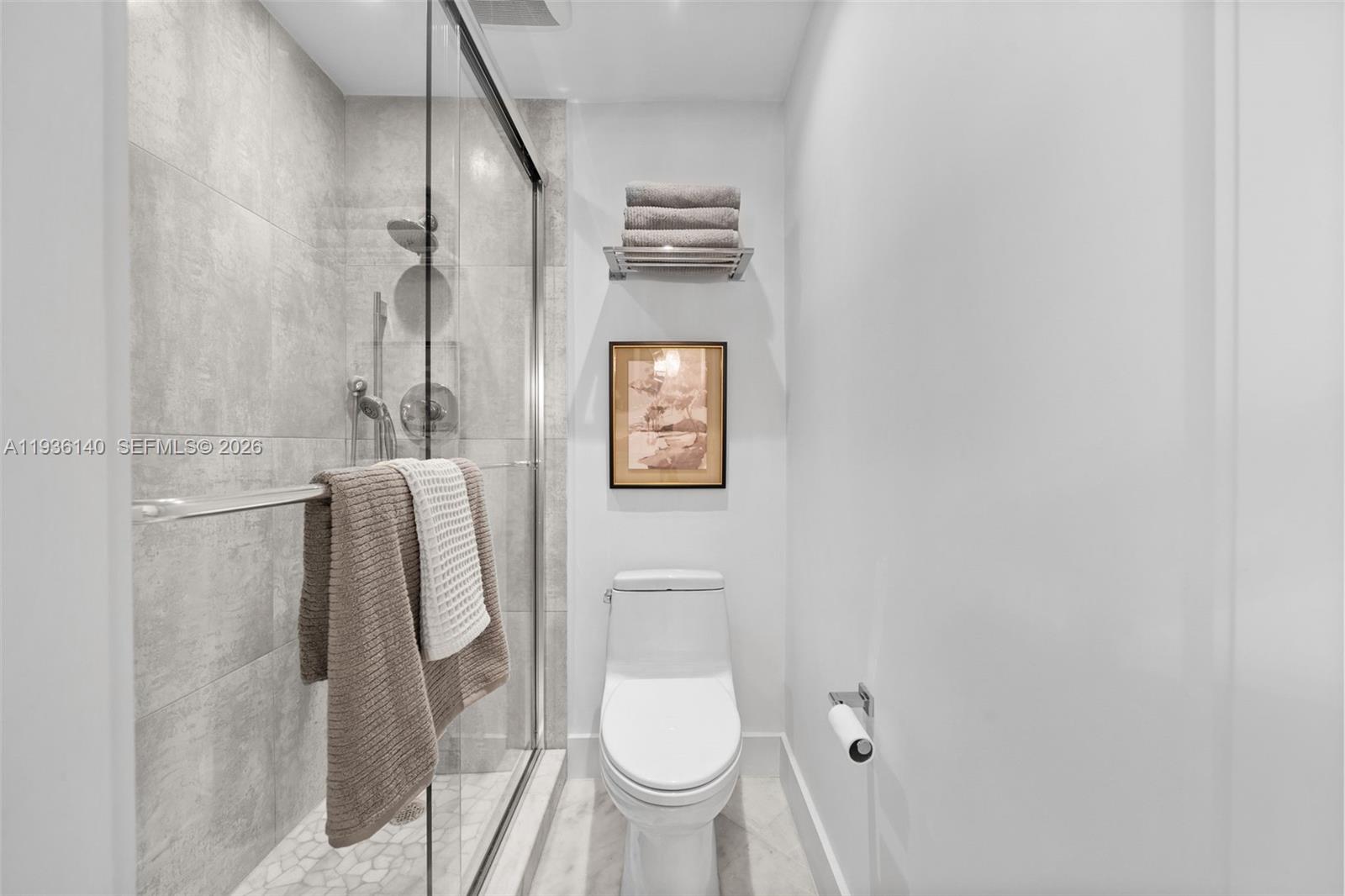 1251 Kane Concourse Bay Harbor Islands, FL 33154 - Photo 19 of 52 a bathroom with a toilet and a shower