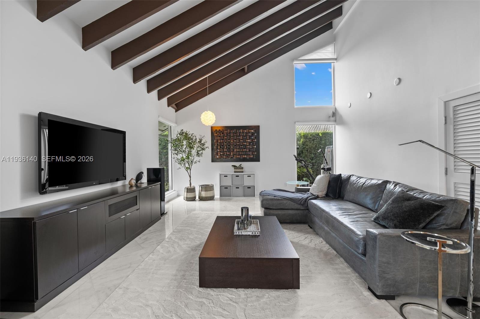 1251 Kane Concourse Bay Harbor Islands, FL 33154 - Photo 20 of 52 a living room with furniture and a flat screen tv