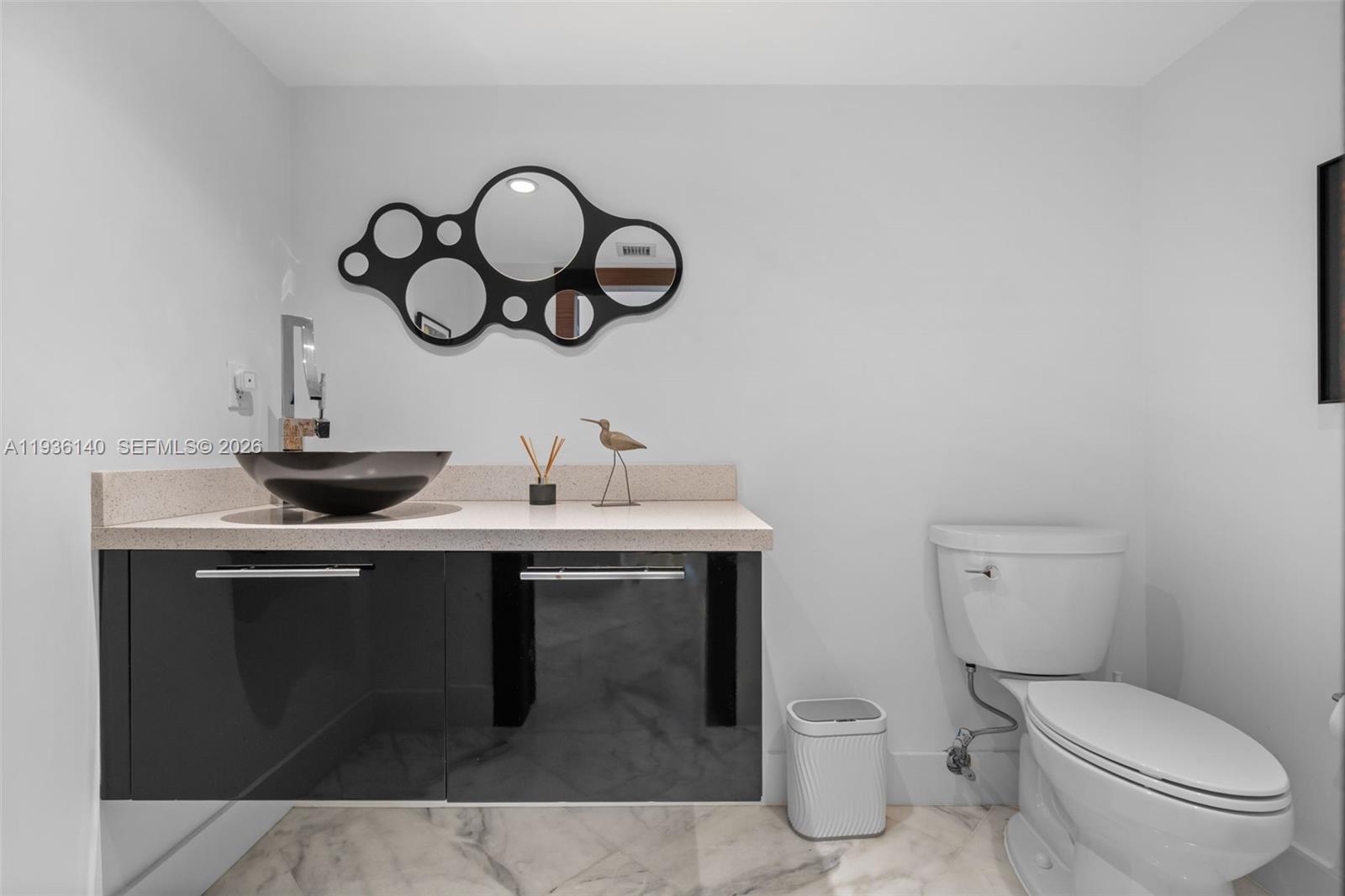 1251 Kane Concourse Bay Harbor Islands, FL 33154 - Photo 25 of 52 a bathroom with a toilet and a sink