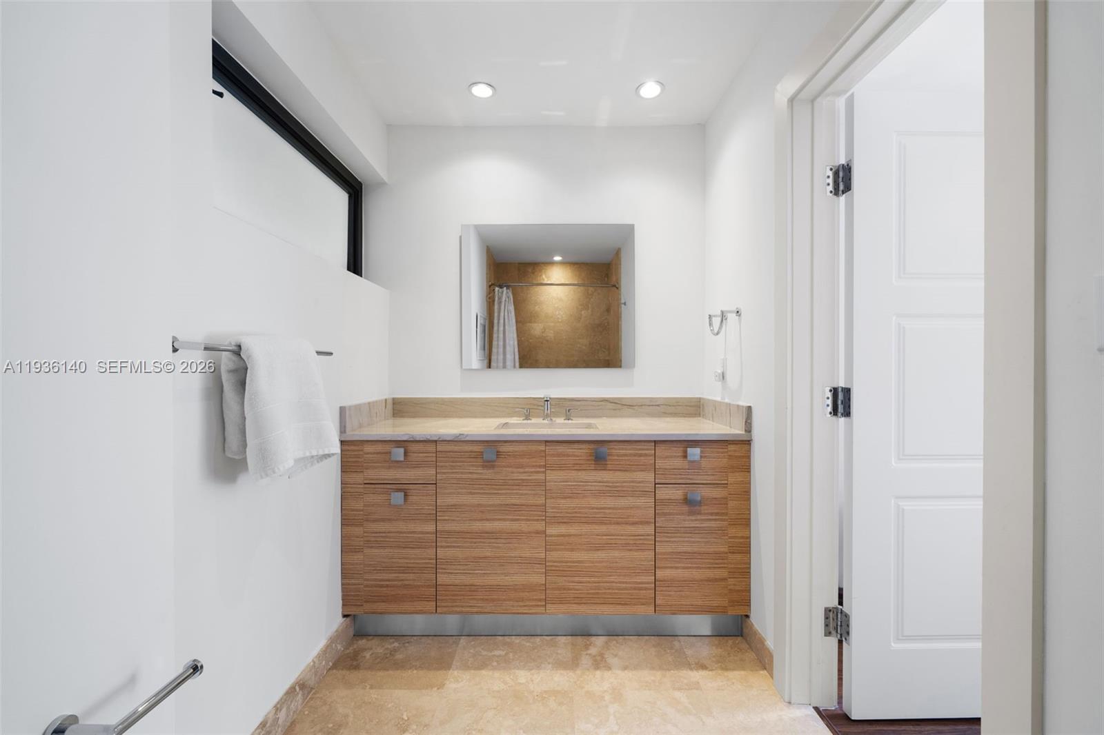 1251 Kane Concourse Bay Harbor Islands, FL 33154 - Photo 33 of 52 a view of bathroom with a sink and a mirror
