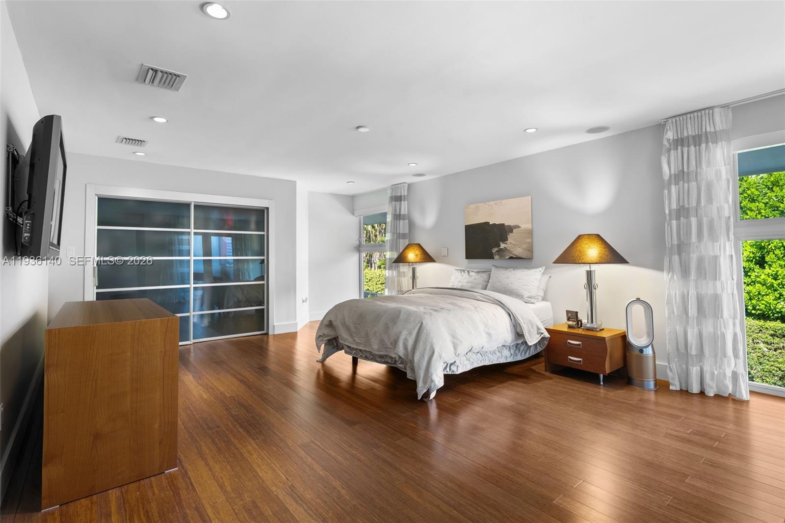 1251 Kane Concourse Bay Harbor Islands, FL 33154 - Photo 34 of 52 a bedroom with a bed and wooden floor