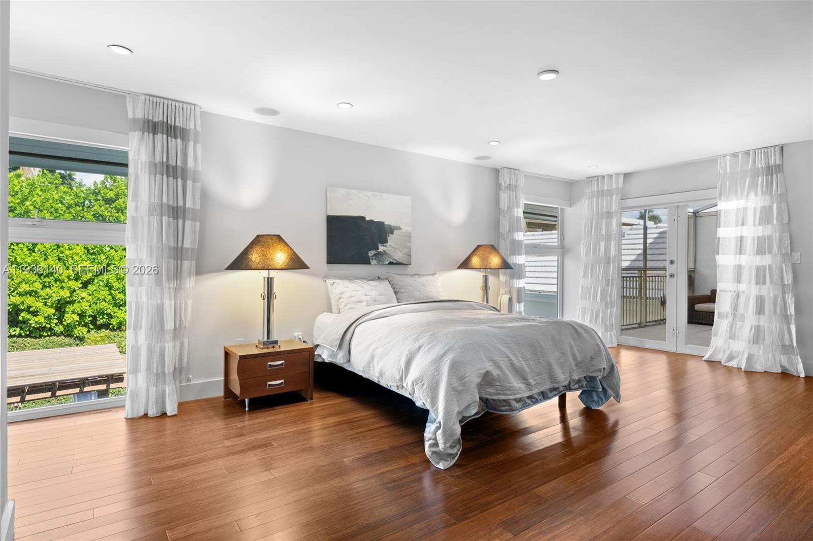 1251 Kane Concourse Bay Harbor Islands, FL 33154 - Photo 35 of 52 a spacious bedroom with a bed and wooden floor