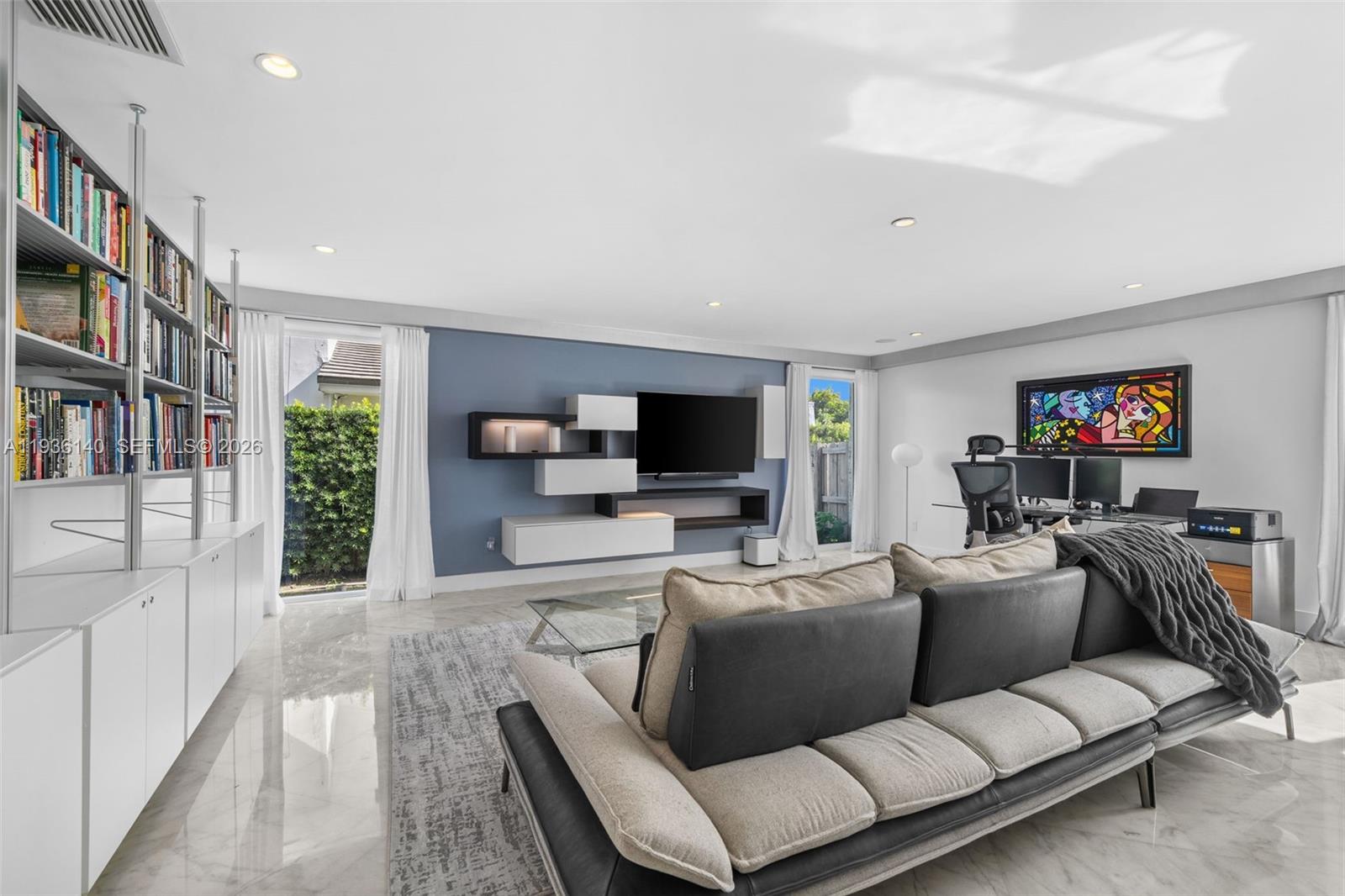 1251 Kane Concourse Bay Harbor Islands, FL 33154 - Photo 4 of 52 a living room with furniture a flat screen tv and a fireplace