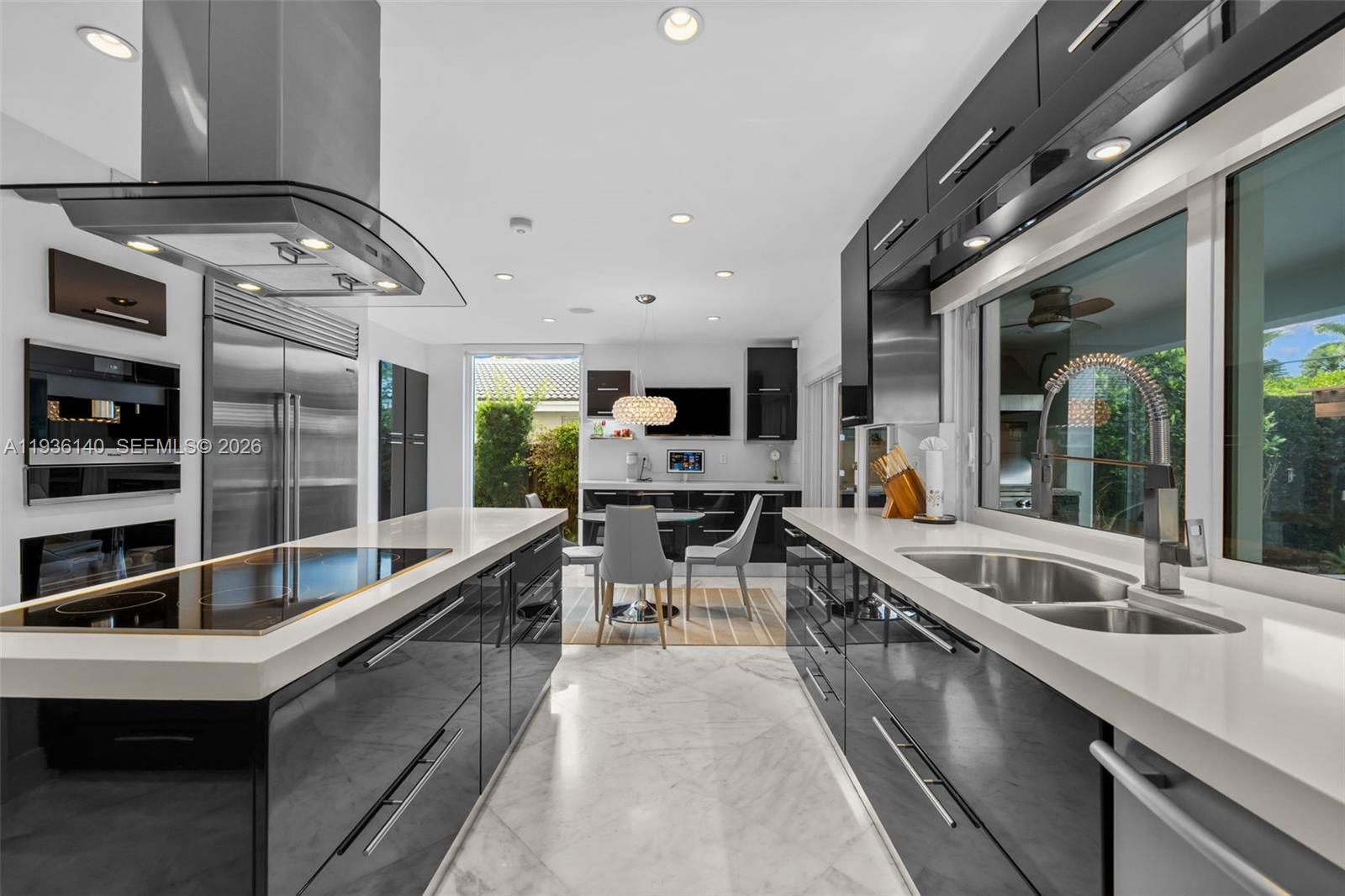 1251 Kane Concourse Bay Harbor Islands, FL 33154 - Photo 6 of 52 a kitchen with stainless steel appliances granite countertop a sink and stove