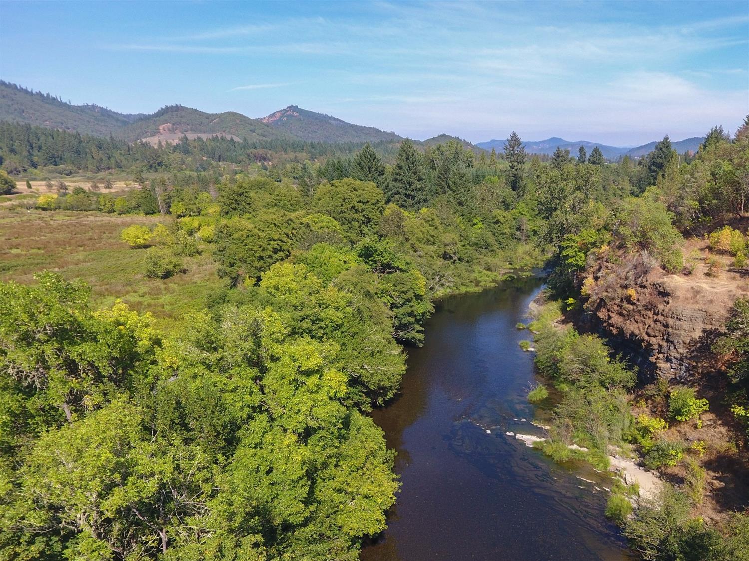 445 Cow Creek Road Riddle, OR 97469 - Photo 5 of 35 a view of a lake with a mountain in the background