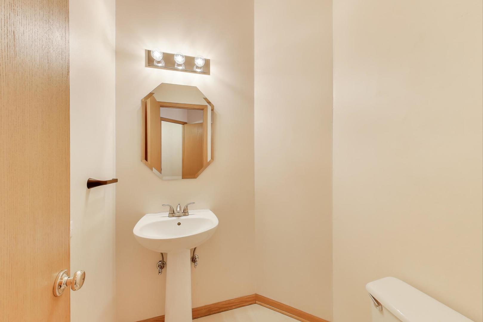 719 Sun Lake Road Lake Villa, IL 60046 - Photo 19 of 46 a bathroom with a toilet sink and mirror
