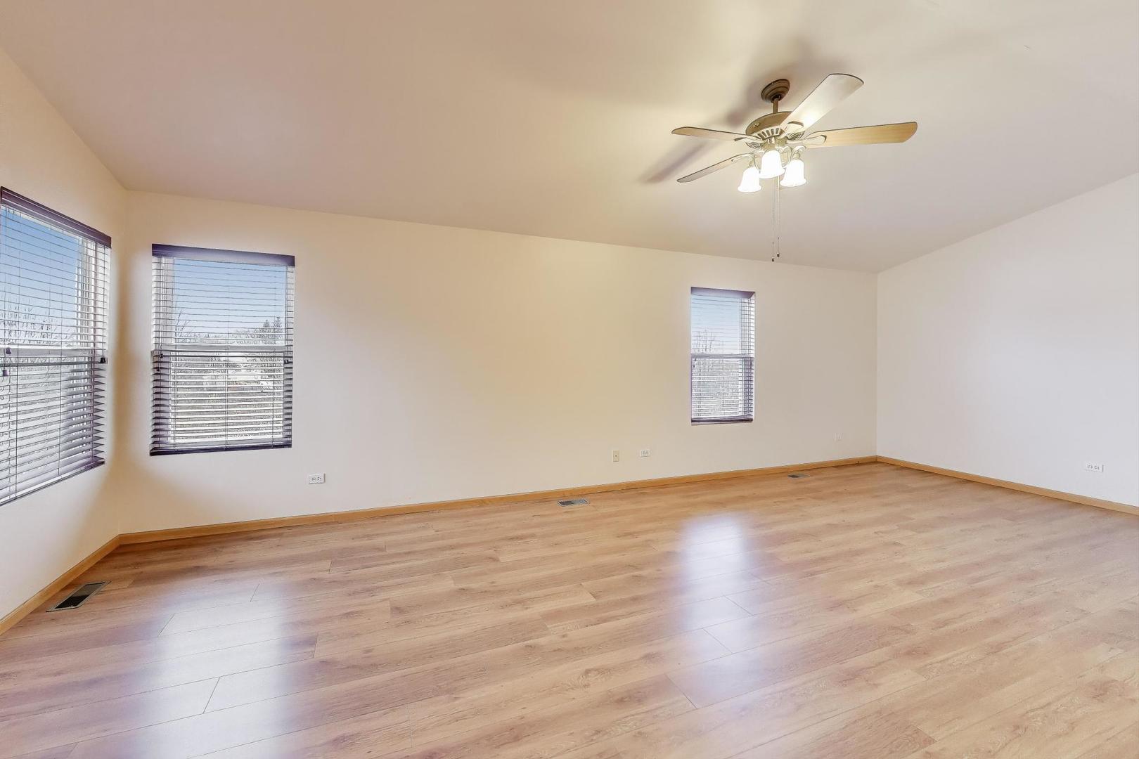 719 Sun Lake Road Lake Villa, IL 60046 - Photo 21 of 46 a view of an empty room with wooden floor and a window