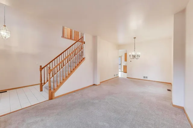 a view of an empty room with stairs