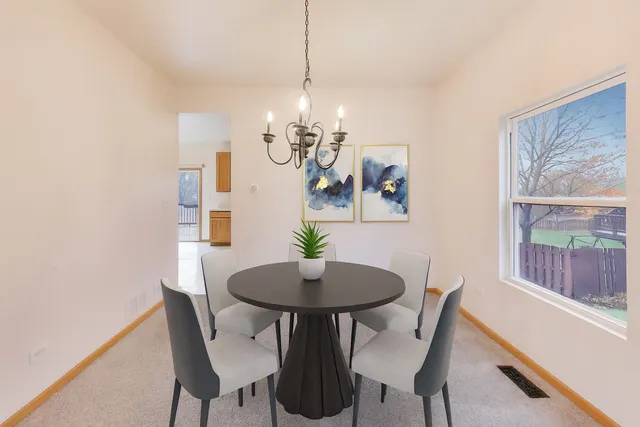 a dining room with furniture and window