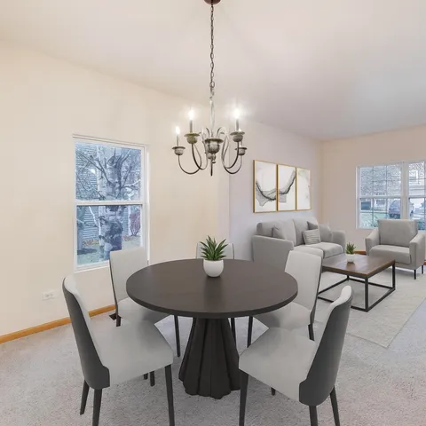 a view of a dining room with furniture a chandelier and wooden floor