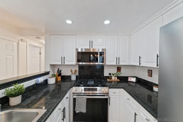 a kitchen filled counter space a sink cabinets and appliances
