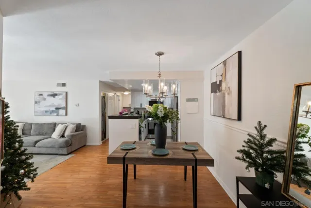 a living room with furniture flowers and a chandelier