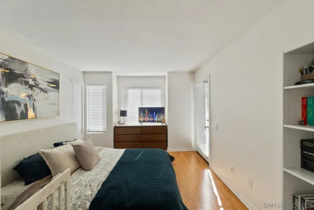 a bedroom with a bed and a painting on the wall