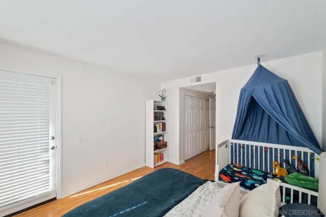 a bathroom with a granite countertop sink a toilet a mirror and shower
