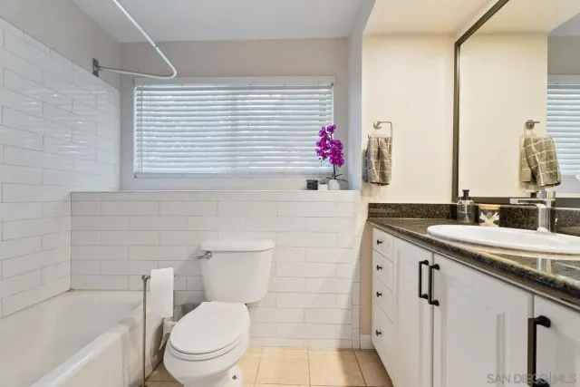 a living room with furniture a bookshelf and a window