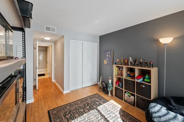a view of a hallway with wooden floor and entryway