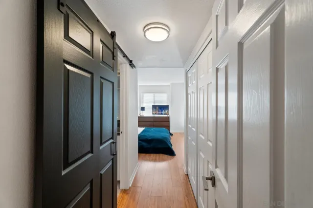 a utility room with mirror and cabinets