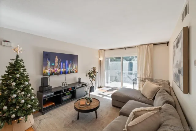 a living room with furniture and flowers
