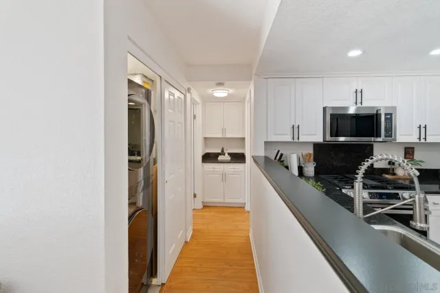 a kitchen with stainless steel appliances granite countertop a refrigerator sink and cabinets