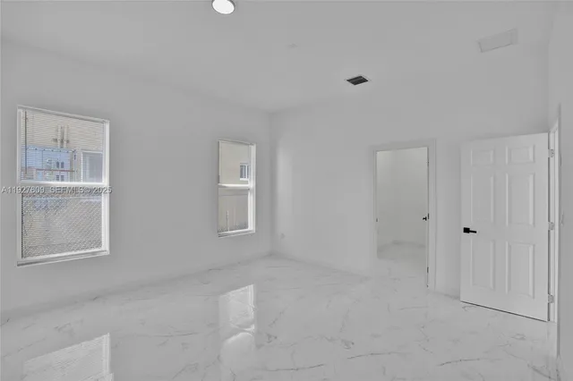 a bathroom with a granite countertop toilet and sink