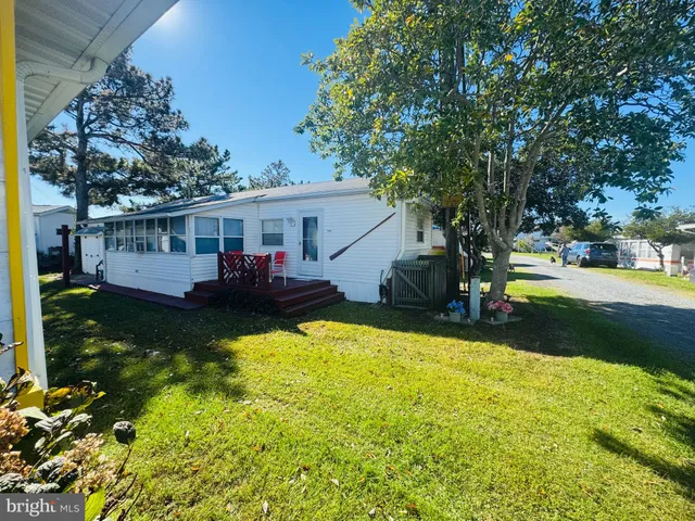 a view of a house with swimming pool and sitting area