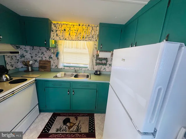 a kitchen with a refrigerator and a sink