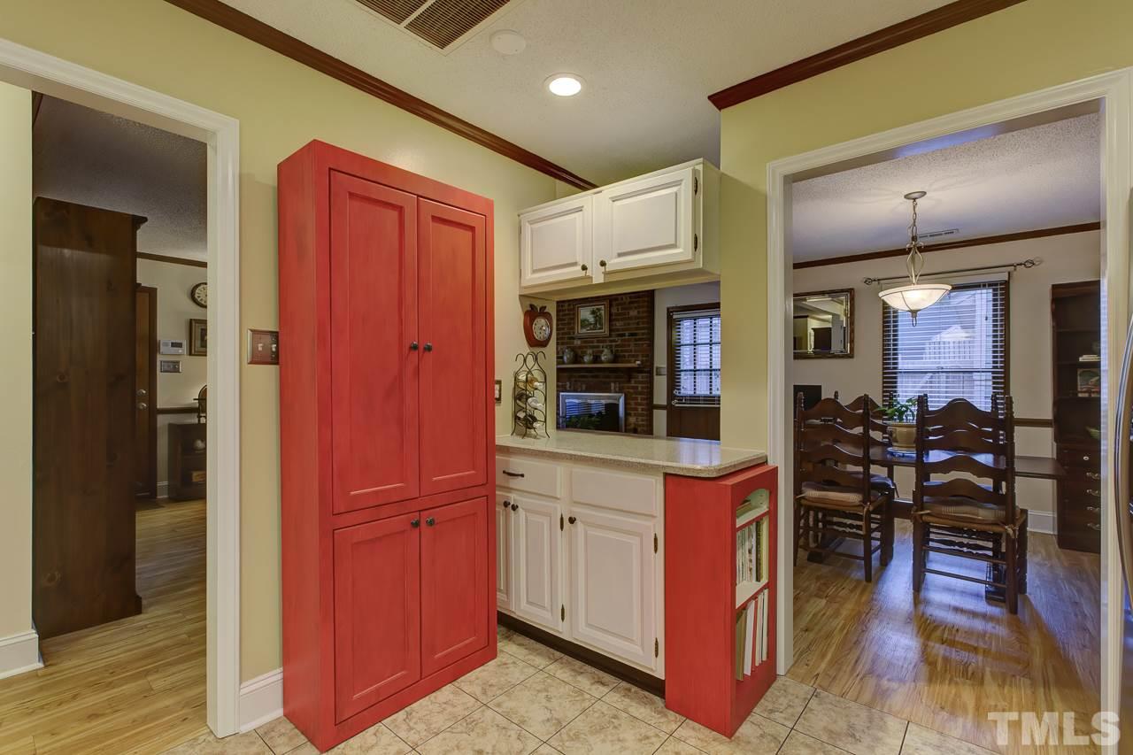 5501 Hamstead Crossing Raleigh, NC 27612 - Photo 12 of 25 a kitchen with stainless steel appliances granite countertop a refrigerator and a wooden cabinets