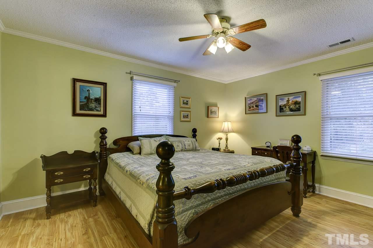 5501 Hamstead Crossing Raleigh, NC 27612 - Photo 13 of 25 a bed room with a bed and a chandelier
