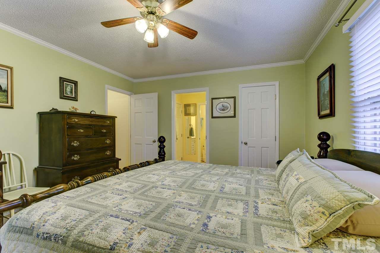 5501 Hamstead Crossing Raleigh, NC 27612 - Photo 14 of 25 a bedroom with a bed and a dresser