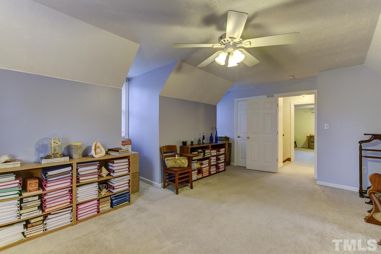 5501 Hamstead Crossing Raleigh, NC 27612 - Photo 20 of 25 a bedroom with furniture and a chandelier fan