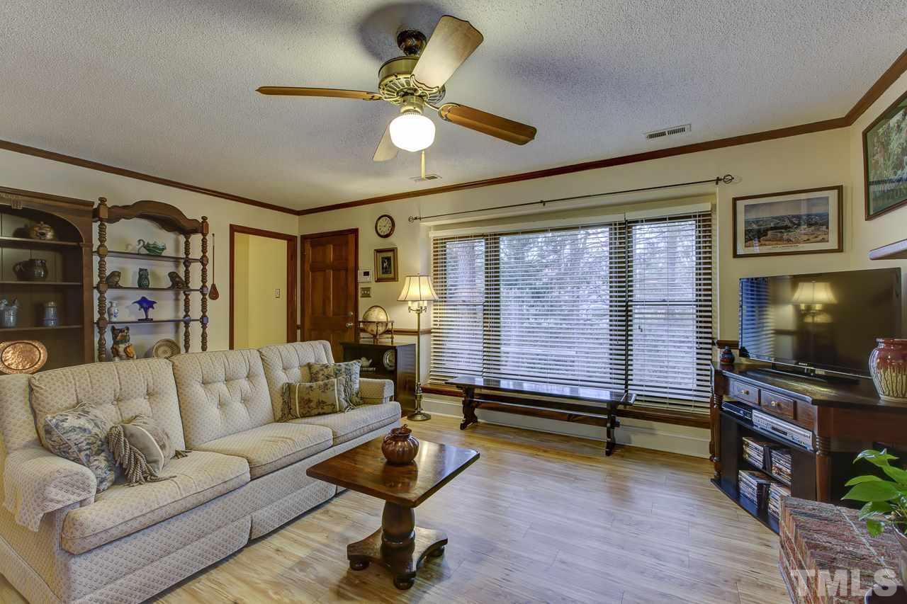 5501 Hamstead Crossing Raleigh, NC 27612 - Photo 4 of 25 a living room with furniture and a flat screen tv