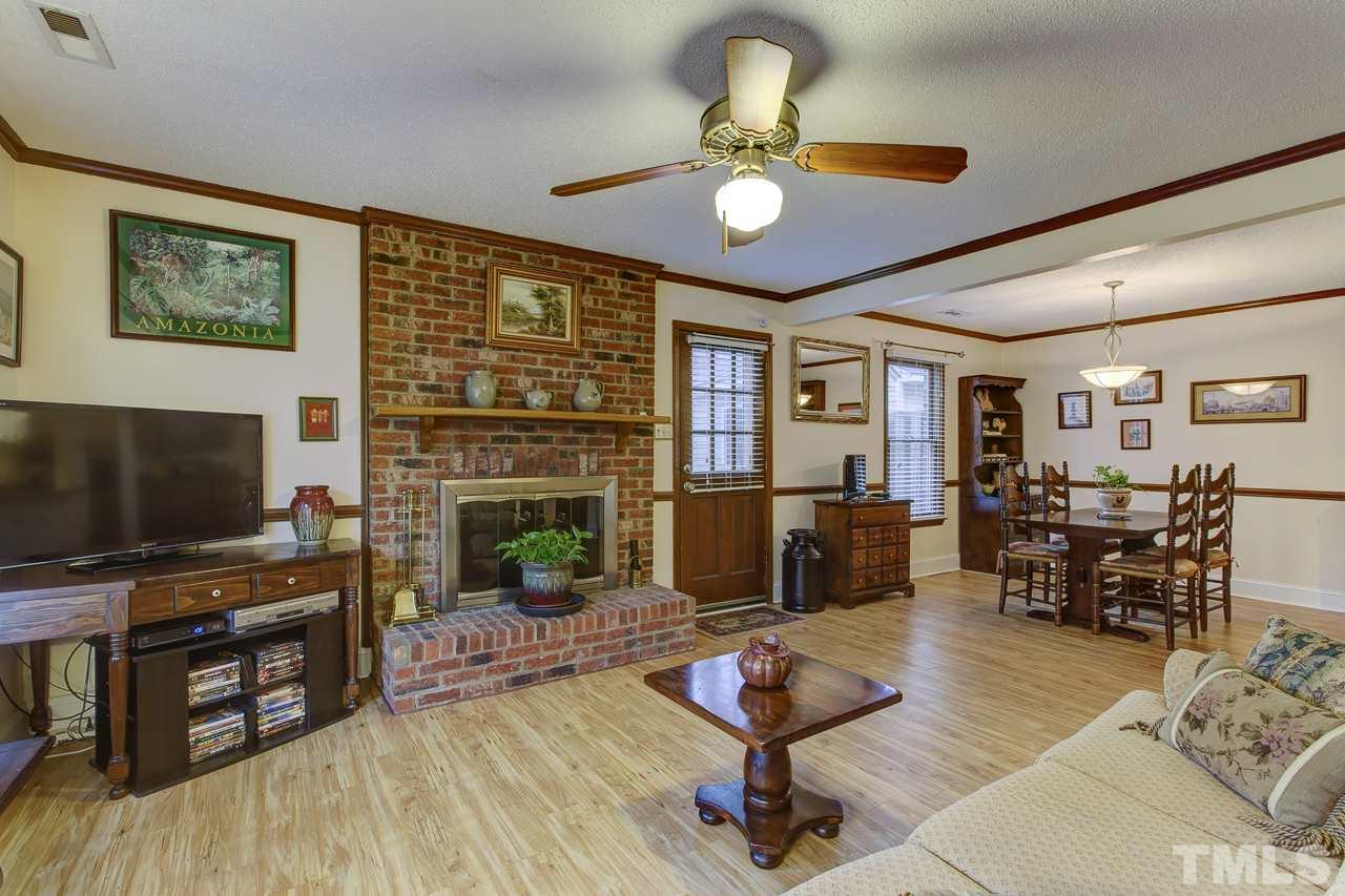 5501 Hamstead Crossing Raleigh, NC 27612 - Photo 5 of 25 a living room with furniture and a flat screen tv with wooden floor
