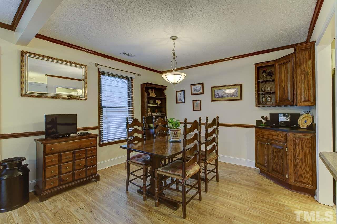 5501 Hamstead Crossing Raleigh, NC 27612 - Photo 8 of 25 a view of a dining room with furniture window and wooden floor