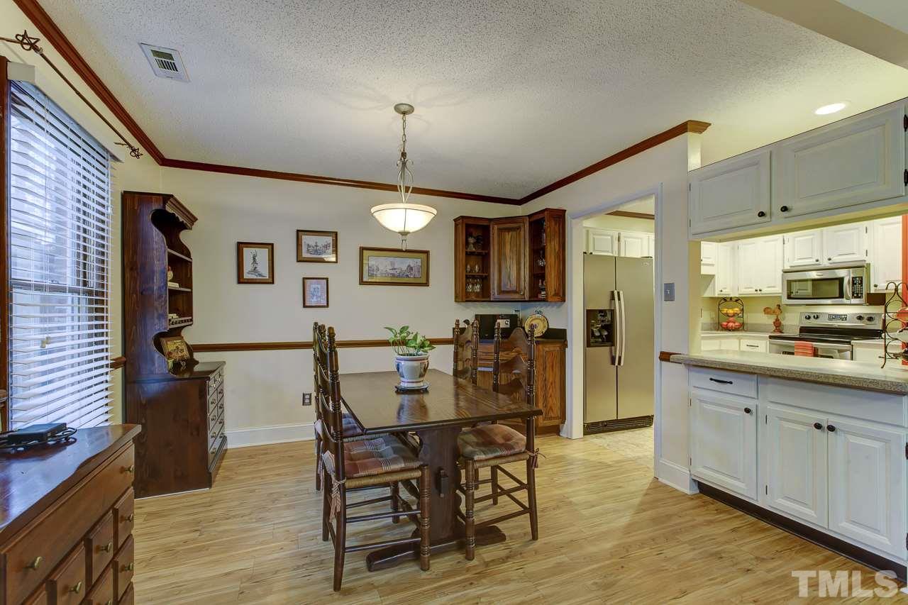 5501 Hamstead Crossing Raleigh, NC 27612 - Photo 9 of 25 a view of a dining room with furniture and a chandelier