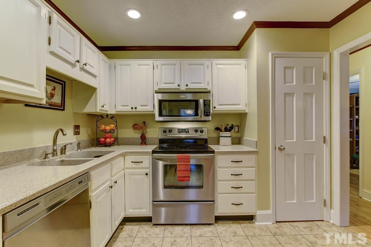 5501 Hamstead Crossing Raleigh, NC 27612 - Photo 10 of 25 a kitchen with cabinets stainless steel appliances and a counter space