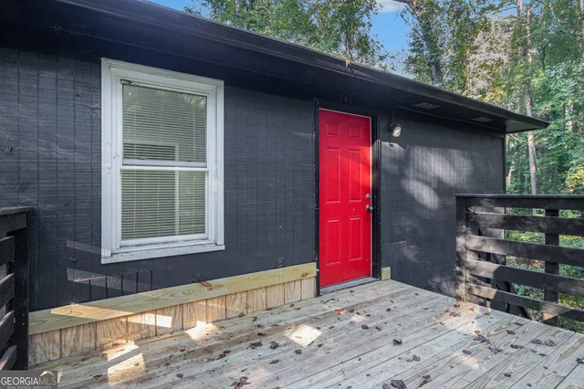 a view of a house with a tree next to a yard